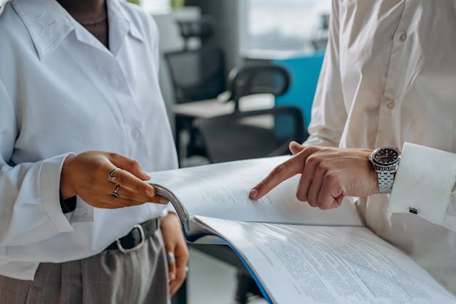 Two people looking at paperwork in a folder